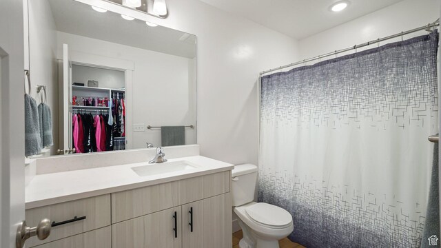 521 W 1110 N Unit Hc4, Logan, UT 84341 - bathroom with toilet, vanity, a spacious closet, and a shower with curtain