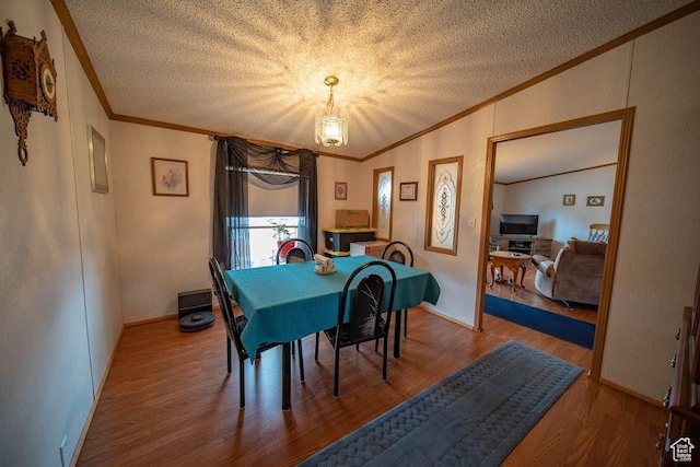 1700 W 2250 N, Helper, UT 84526 - dining area with ornamental molding, a textured ceiling, wood finished floors, and a chandelier