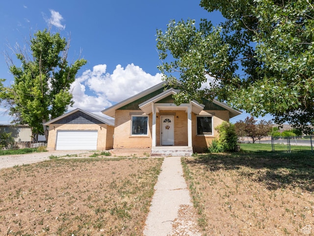 97 N 400 W, Aurora, UT 84620 - view of front of home with driveway, a garage, and brick siding