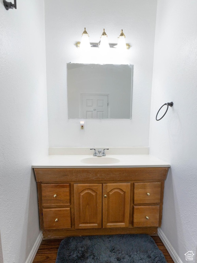 97 N 400 W, Aurora, UT 84620 - bathroom featuring vanity, wood finished floors, and baseboards