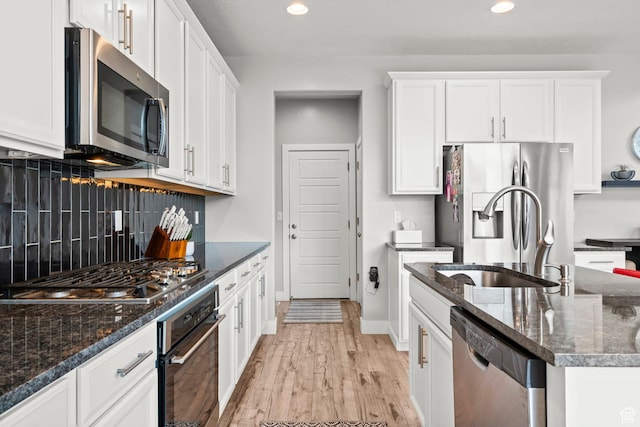 159 E Tranquil Cir, Saratoga Springs, UT 84045 - kitchen featuring appliances with stainless steel finishes, tasteful backsplash, white cabinets, light wood-style flooring, and recessed lighting