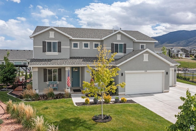 159 E Tranquil Cir, Saratoga Springs, UT 84045 - traditional-style home with concrete driveway, stucco siding, a mountain view, a front yard, and a porch