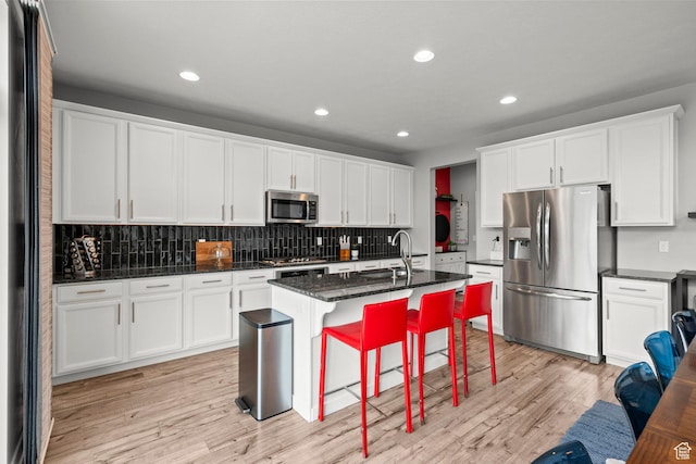 159 E Tranquil Cir, Saratoga Springs, UT 84045 - kitchen featuring appliances with stainless steel finishes, a sink, light wood finished floors, backsplash, and recessed lighting