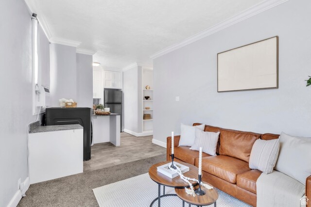 29 S State St Unit 216, Salt Lake City, UT 84111 - living room with crown molding, baseboards, and light carpet
