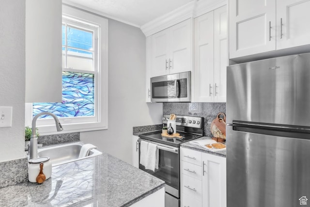 29 S State St Unit 216, Salt Lake City, UT 84111 - kitchen with appliances with stainless steel finishes, a sink, white cabinets, and ornamental molding