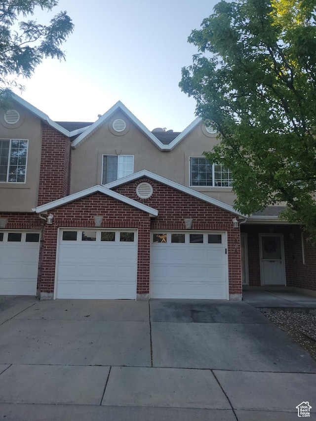 3878 W Sage Willow Dr, South Jordan, UT 84009 - view of front of property featuring concrete driveway, stucco siding, an attached garage, and brick siding