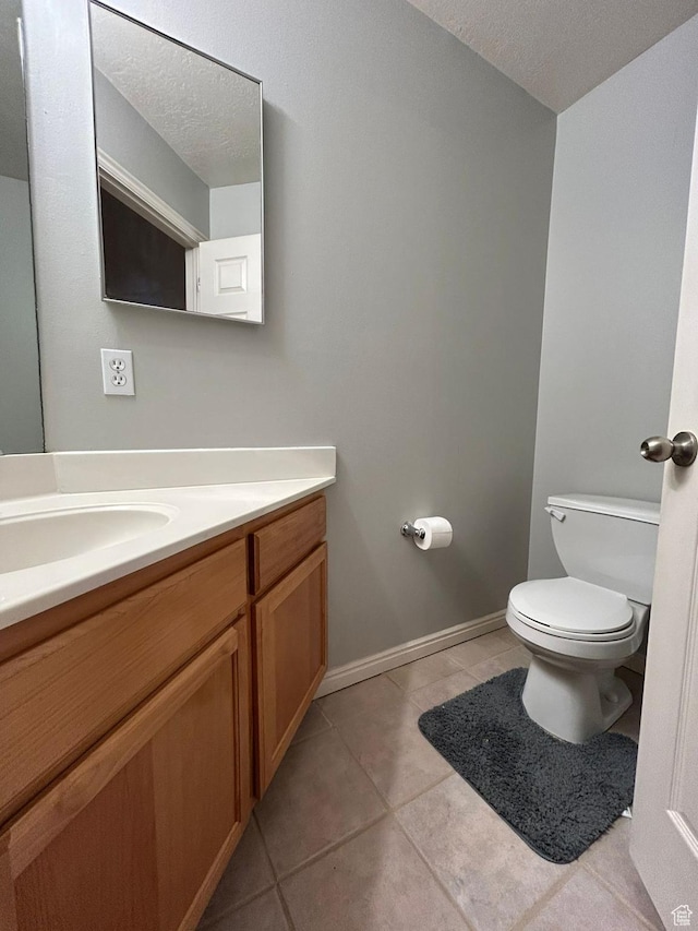 3878 W Sage Willow Dr, South Jordan, UT 84009 - half bath with vanity, toilet, tile patterned floors, baseboards, and a textured ceiling