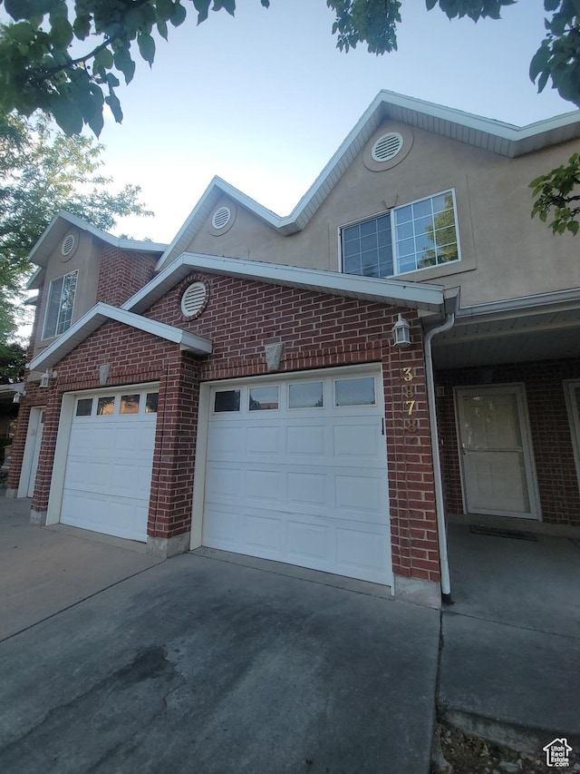 3878 W Sage Willow Dr, South Jordan, UT 84009 - view of property exterior with brick siding, driveway, and a garage