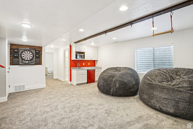 13326 S Rochdale Ln W, Herriman, UT 84096 - living area featuring recessed lighting, light carpet, a textured ceiling, and bar with sink