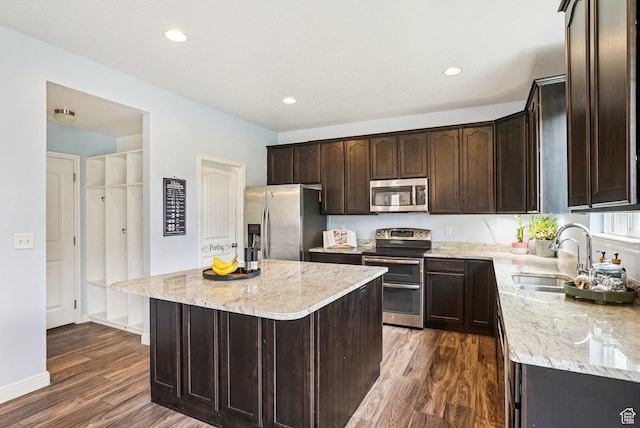13326 S Rochdale Ln W, Herriman, UT 84096 - kitchen with stainless steel appliances, dark brown cabinetry, dark wood-type flooring, light stone countertops, and recessed lighting
