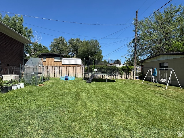 2557 W 5725 S, Roy, UT 84067 - view of yard featuring a trampoline and an outdoor structure