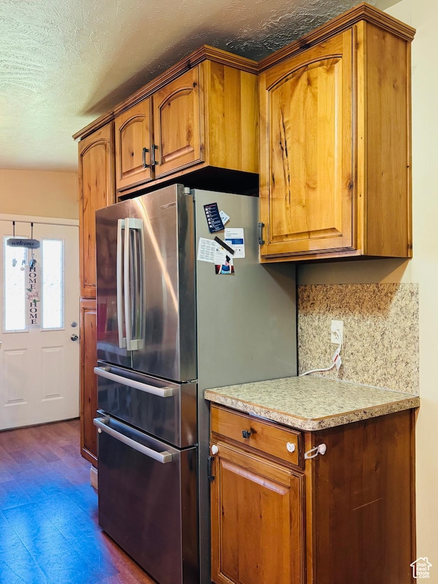 2557 W 5725 S, Roy, UT 84067 - kitchen with freestanding refrigerator, brown cabinetry, light countertops, a textured ceiling, and dark floors