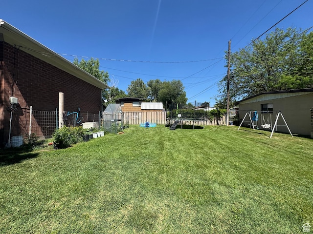 2557 W 5725 S, Roy, UT 84067 - view of yard featuring a trampoline and a playground