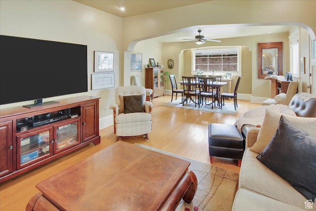 623 E Milton Ave, Salt Lake City, UT 84105 - living room featuring arched walkways, ceiling fan, and light wood-type flooring