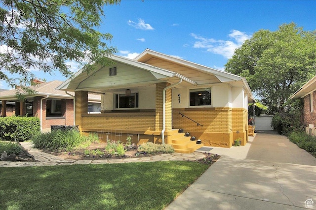 623 E Milton Ave, Salt Lake City, UT 84105 - view of front of property with brick siding, a porch, and a front yard