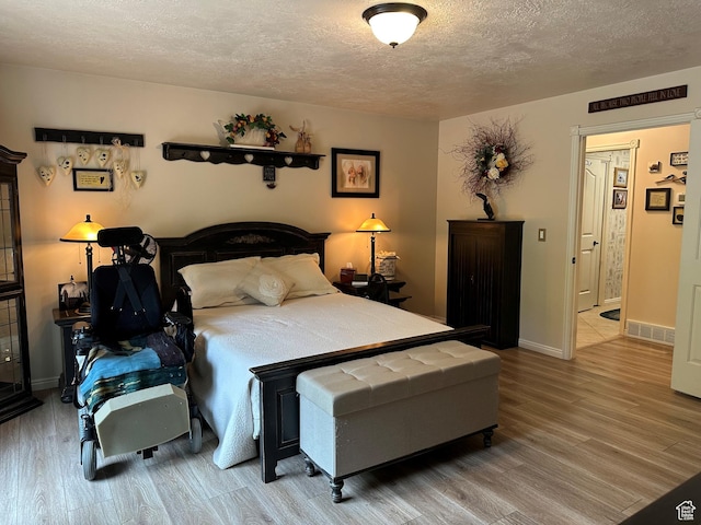1262 W Dusty Downs Cir S, Jordan, UT 84095 - bedroom featuring a textured ceiling, wood finished floors, and baseboards
