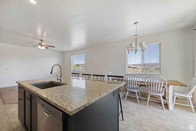 258 N Windsor Dr, Washington, UT 84780 - kitchen with dishwasher, a sink, a ceiling fan, a kitchen island with sink, and baseboards