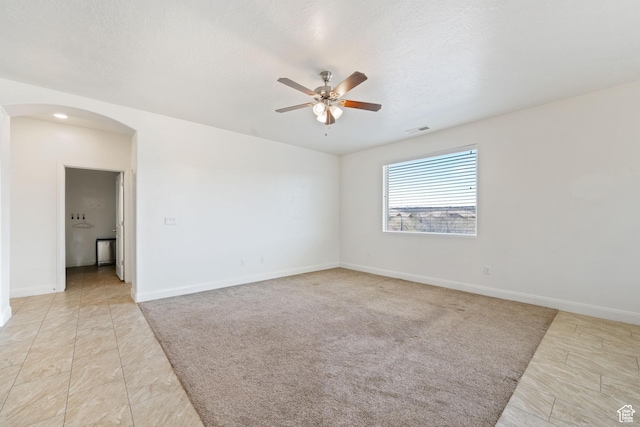 258 N Windsor Dr, Washington, UT 84780 - unfurnished room featuring arched walkways, ceiling fan, baseboards, and light tile patterned floors