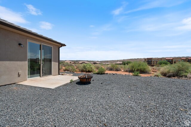 258 N Windsor Dr, Washington, UT 84780 - view of yard featuring a fire pit and a patio