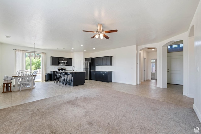 258 N Windsor Dr, Washington, UT 84780 - living area featuring light carpet, arched walkways, ceiling fan, and baseboards