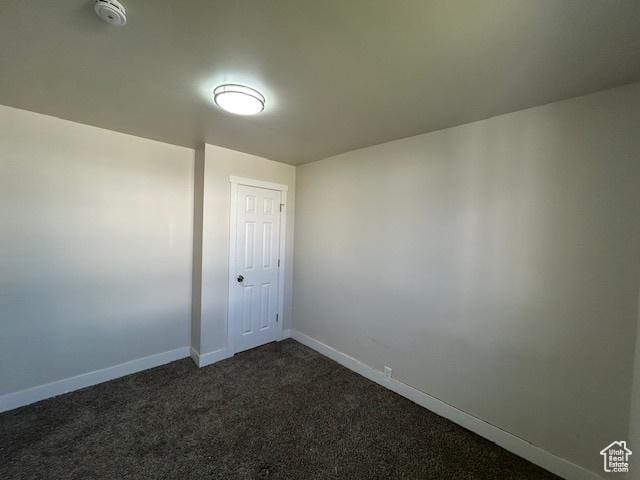 393 W 200 S, Tooele, UT 84074 - empty room featuring a smoke detector, baseboards, and dark carpet