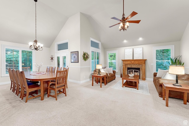 2221 E Fisher Ln S, Salt Lake City, UT 84109 - dining room with a fireplace, a chandelier, light carpet, high vaulted ceiling, and baseboards