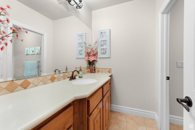 2221 E Fisher Ln S, Salt Lake City, UT 84109 - bathroom featuring vanity, tile patterned floors, baseboards, and tasteful backsplash