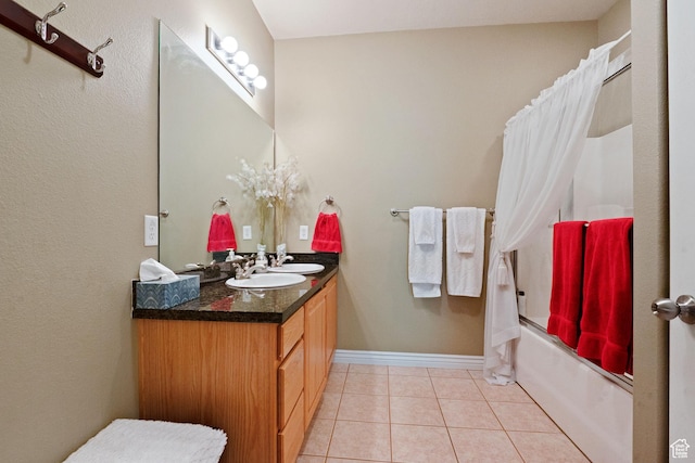 1174 E 3300 S Unit 417, Millcreek, UT 84106 - full bathroom with double vanity, shower / bath combo with shower curtain, tile patterned flooring, and baseboards