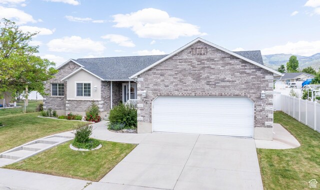 675 S 30 E, Ephraim, UT 84627 - single story home with an attached garage, driveway, brick siding, and a mountain view