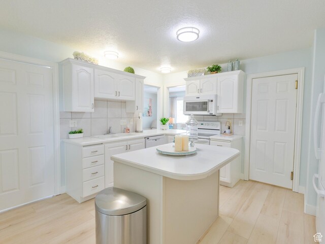 675 S 30 E, Ephraim, UT 84627 - kitchen featuring white appliances, a sink, backsplash, light countertops, and white cabinetry