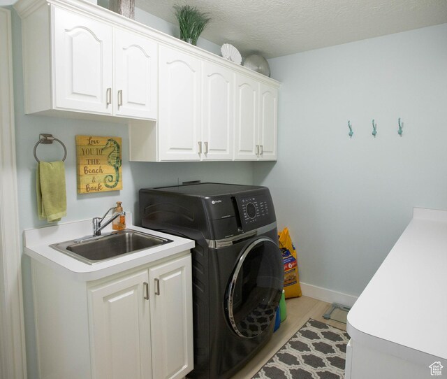 675 S 30 E, Ephraim, UT 84627 - laundry room featuring cabinet space, washer / dryer, light wood-style floors, and baseboards