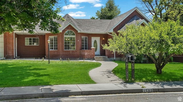 1580 E 1630 N, North Logan, UT 84341 - view of front of property featuring a front yard, roof with shingles, and brick siding