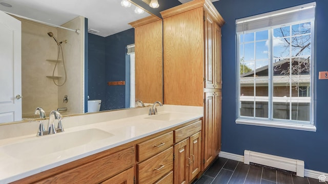 1580 E 1630 N, North Logan, UT 84341 - full bathroom featuring baseboards, a baseboard radiator, double vanity, toilet, and a shower