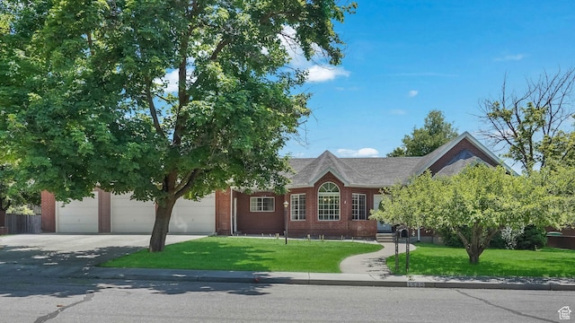 1580 E 1630 N, North Logan, UT 84341 - view of front of home with driveway, a front lawn, brick siding, and an attached garage