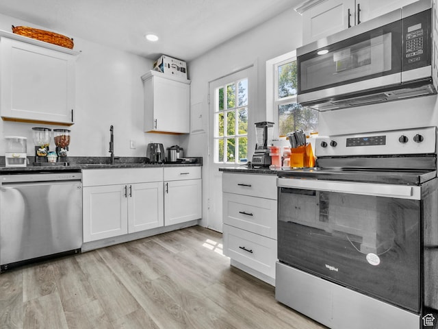 60 S Whiteside St, Layton, UT 84041 - kitchen with stainless steel appliances, light wood-style floors, white cabinets, a sink, and recessed lighting