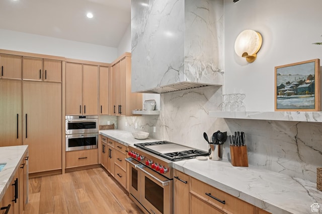 1988 Stone Creek Rd Unit 19, Park City, UT 84098 - kitchen featuring appliances with stainless steel finishes, wall chimney exhaust hood, light wood-style floors, backsplash, and light stone counters