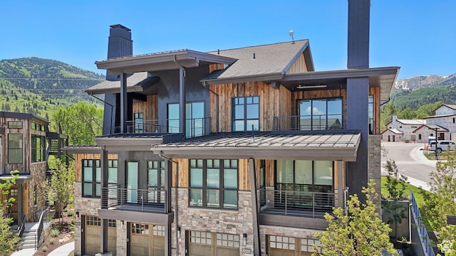 1988 Stone Creek Rd Unit 19, Park City, UT 84098 - back of property with a balcony, a chimney, a standing seam roof, and a mountain view
