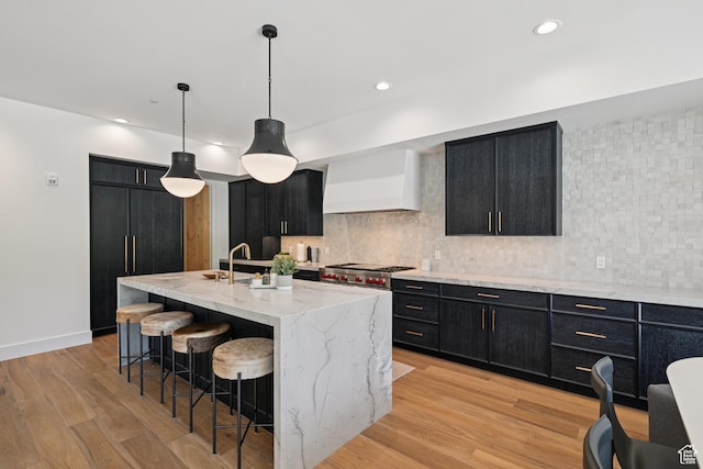 1988 Stone Creek Rd Unit 19, Park City, UT 84098 - kitchen with dark cabinetry, premium range hood, decorative backsplash, and recessed lighting