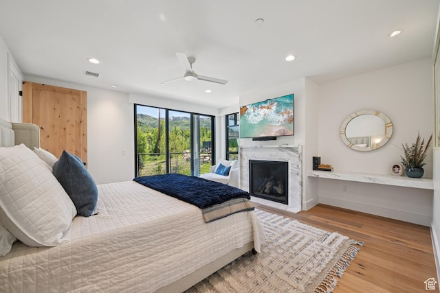 1988 Stone Creek Rd Unit 19, Park City, UT 84098 - bedroom featuring access to outside, a premium fireplace, wood finished floors, recessed lighting, and ceiling fan