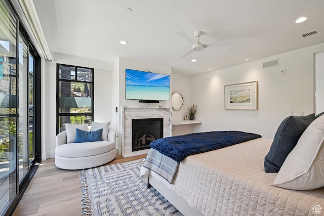 1988 Stone Creek Rd Unit 19, Park City, UT 84098 - bedroom featuring wood finished floors, multiple windows, recessed lighting, a high end fireplace, and a ceiling fan