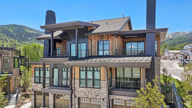 1990 Stone Creek Rd Unit 20, Park City, UT 84098 - back of property with a balcony, a chimney, a standing seam roof, and a mountain view