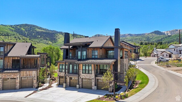 1990 Stone Creek Rd Unit 20, Park City, UT 84098 - view of front facade with a balcony, a garage, a standing seam roof, concrete driveway, and a chimney