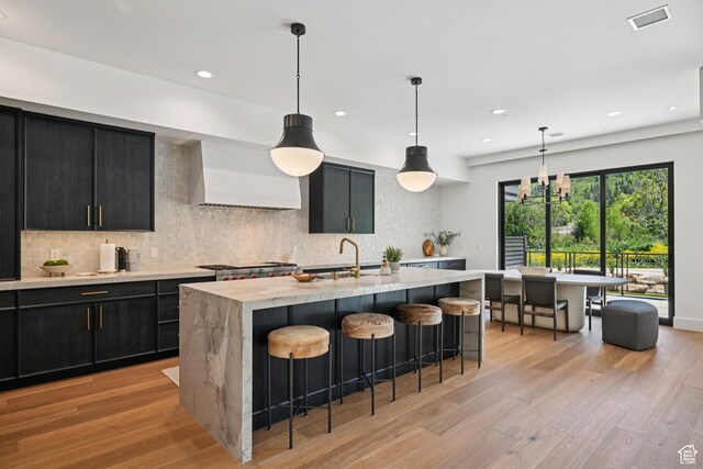 1990 Stone Creek Rd Unit 20, Park City, UT 84098 - kitchen with dark cabinetry, a sink, premium range hood, light wood-style flooring, and recessed lighting