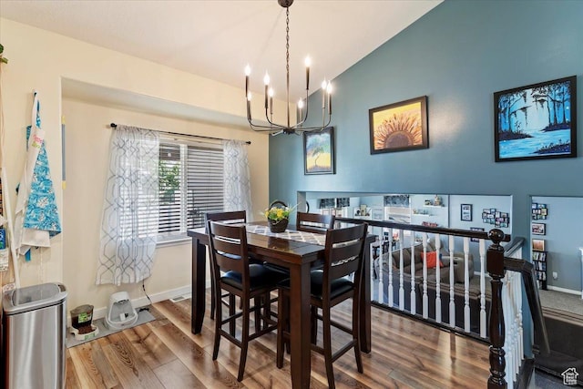 298 W 1775 N, Harrisville, UT 84414 - dining area featuring vaulted ceiling, a chandelier, wood finished floors, and baseboards