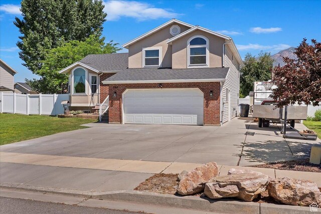 298 W 1775 N, Harrisville, UT 84414 - view of front facade featuring driveway, brick siding, a garage, and a shingled roof