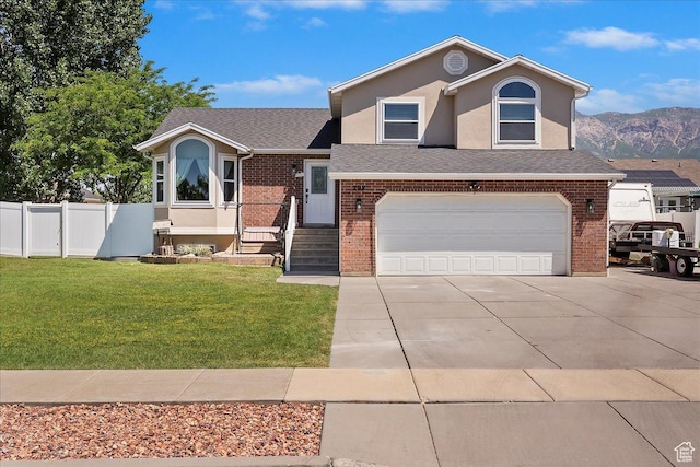 298 W 1775 N, Harrisville, UT 84414 - view of front of house featuring concrete driveway, an attached garage, brick siding, and a mountain view
