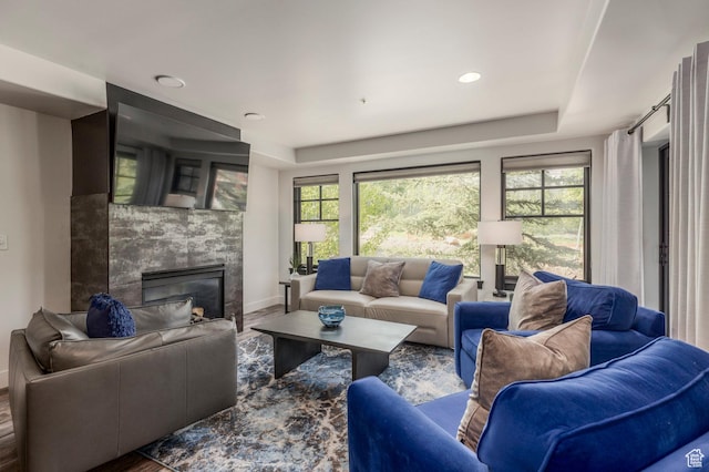 2900 Deer Valley Dr E Unit E211, Deer Valley, UT 84060 - living area with a tray ceiling, baseboards, a tile fireplace, and wood finished floors