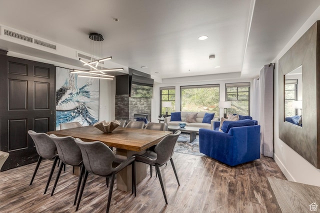 2900 Deer Valley Dr E Unit E211, Deer Valley, UT 84060 - dining area with wood finished floors, a tiled fireplace, baseboards, and a chandelier