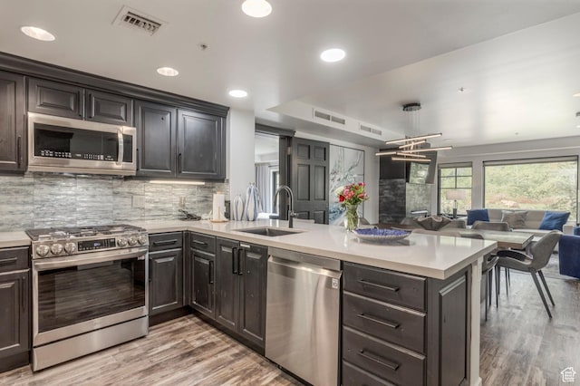 2900 Deer Valley Dr E Unit E211, Deer Valley, UT 84060 - kitchen featuring stainless steel appliances, a sink, a peninsula, open floor plan, and light countertops