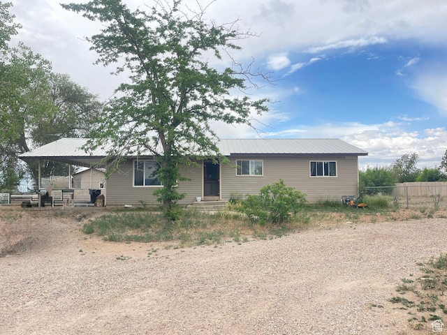 3301 S 1500 E, Vernal, UT 84078 - ranch-style house featuring dirt driveway, metal roof, an attached carport, and entry steps
